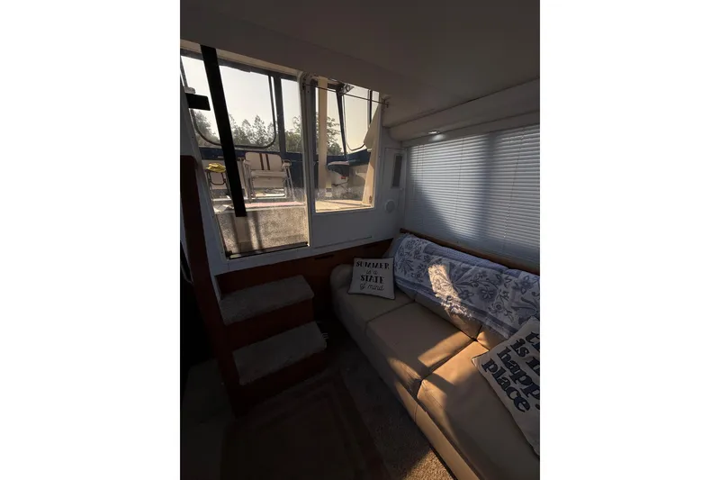 Slide: The Image of Interior of 1992 Carver 33 Aft Cabin Motor Yacht with cozy seating and decor. - 31