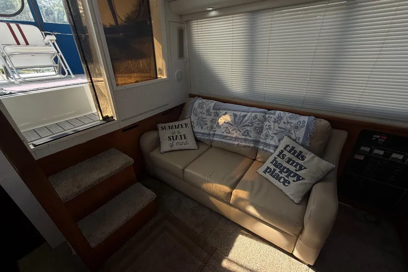 Slide: The Image of Interior of 1992 Carver 33 Aft Cabin Motor Yacht with cozy seating and decorative pillows. - 32