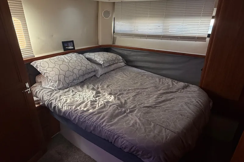 Slide: The Image of Cozy bedroom in 1992 Carver 33 Aft Cabin Motor Yacht with comfortable bedding and window blinds. - 45