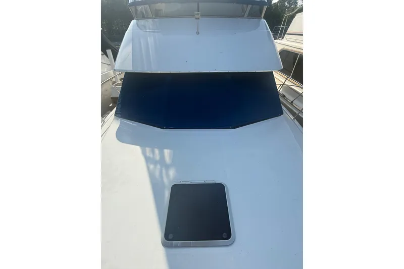 Slide: The Image of 1992 Carver 33 Aft Cabin Motor Yacht with blue windshield cover and deck hatch. - 9