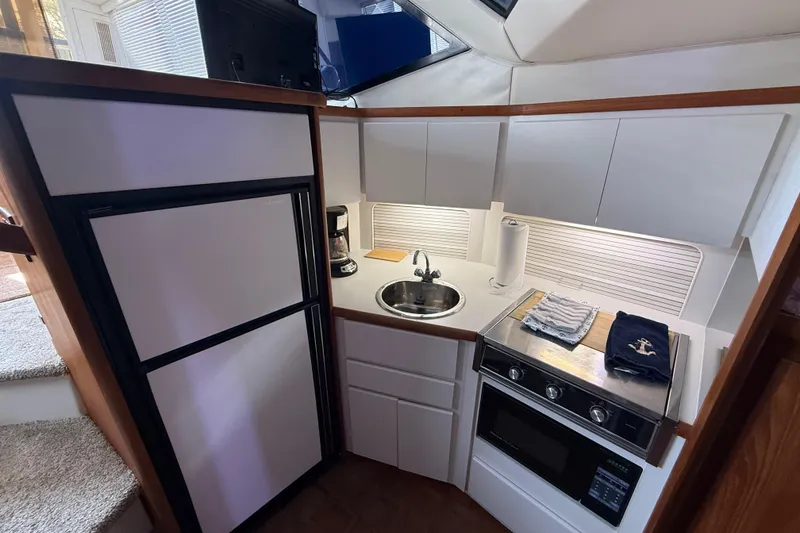 Slide: The Image of Compact kitchen in a 1992 Carver 33 Aft Cabin Motor Yacht with modern amenities. - 36