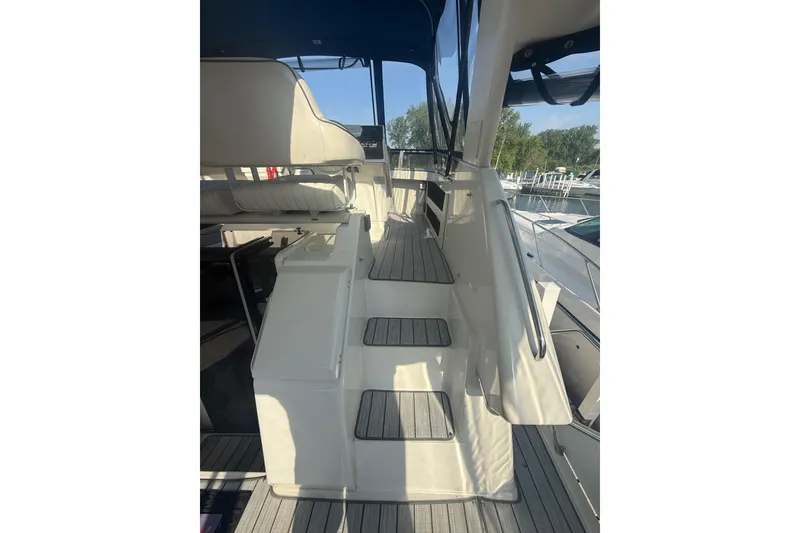 Slide: The Image of 1992 Carver 33 Aft Cabin Motor Yacht interior with seating and steps, docked at marina. - 19