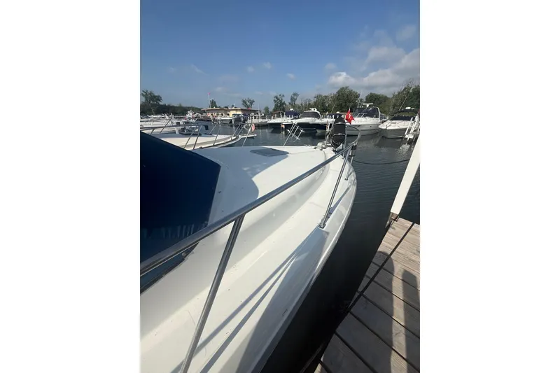 Slide: The Image of 1992 Carver 33 Aft Cabin Motor Yacht docked at marina under clear sky. - 5