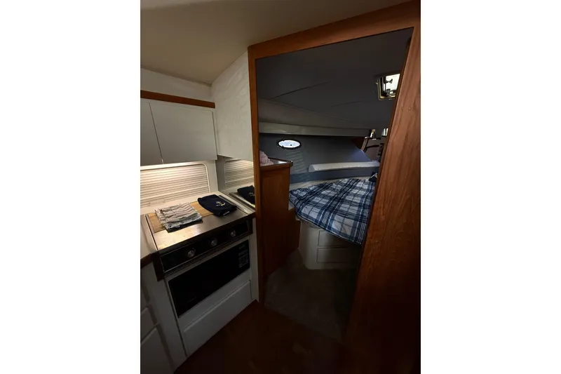 Slide: The Image of Interior of 1992 Carver 33 Aft Cabin Motor Yacht, featuring cozy cabin and compact kitchen. - 35