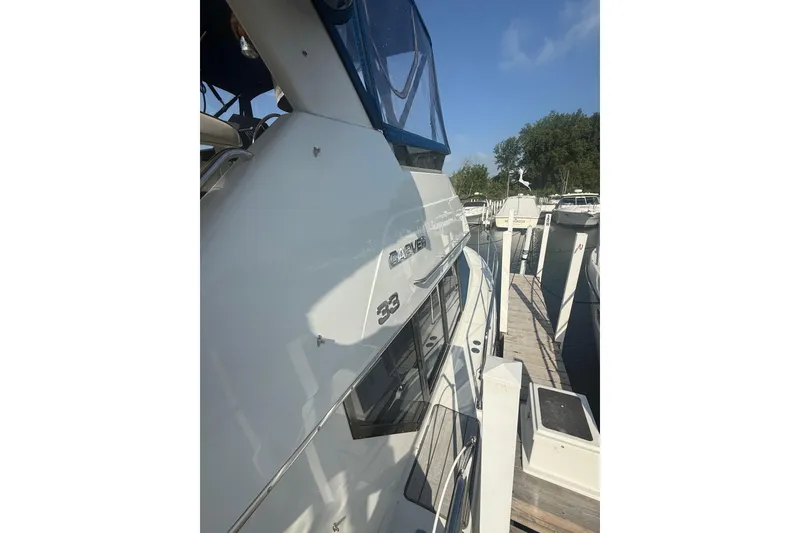 Slide: The Image of 1992 Carver 33 Aft Cabin Motor Yacht docked at marina under clear sky. - 14