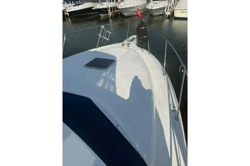 Slide: The Image of 1992 Carver 33 Aft Cabin Motor Yacht deck view at marina. - 6