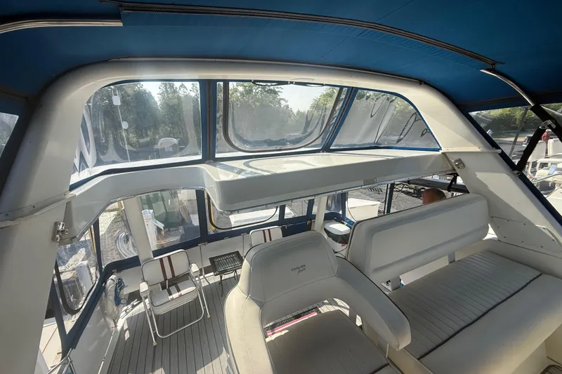 Slide: The Image of Interior view of 1992 Carver 33 Aft Cabin Motor Yacht with seating and windows. - 26
