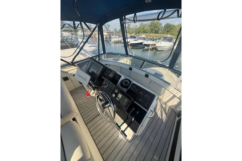 Slide: The Image of 1992 Carver 33 Aft Cabin Motor Yacht helm with Garmin navigation, docked at marina. - 22