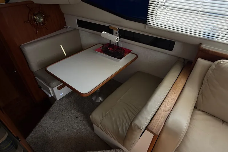 Slide: The Image of Interior of 1992 Carver 33 Aft Cabin Motor Yacht with dining area and seating. - 33
