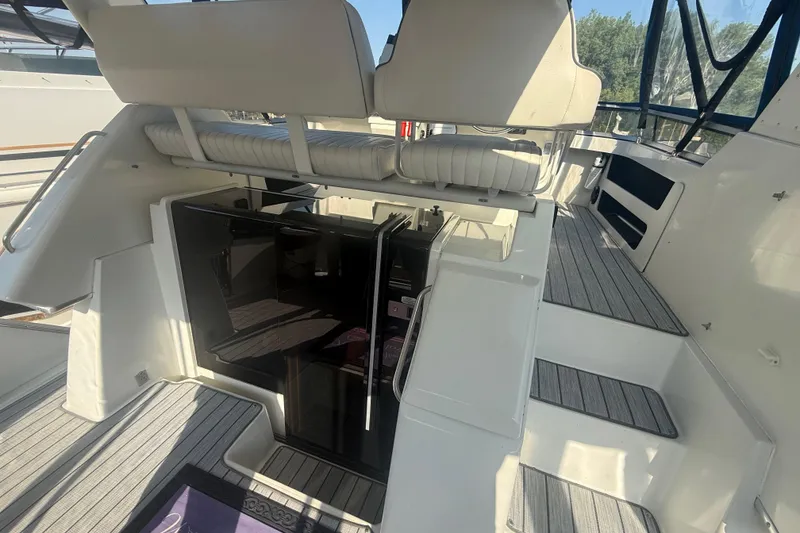 Slide: The Image of 1992 Carver 33 Aft Cabin Motor Yacht interior with seating and stairs, showcasing luxury design. - 18