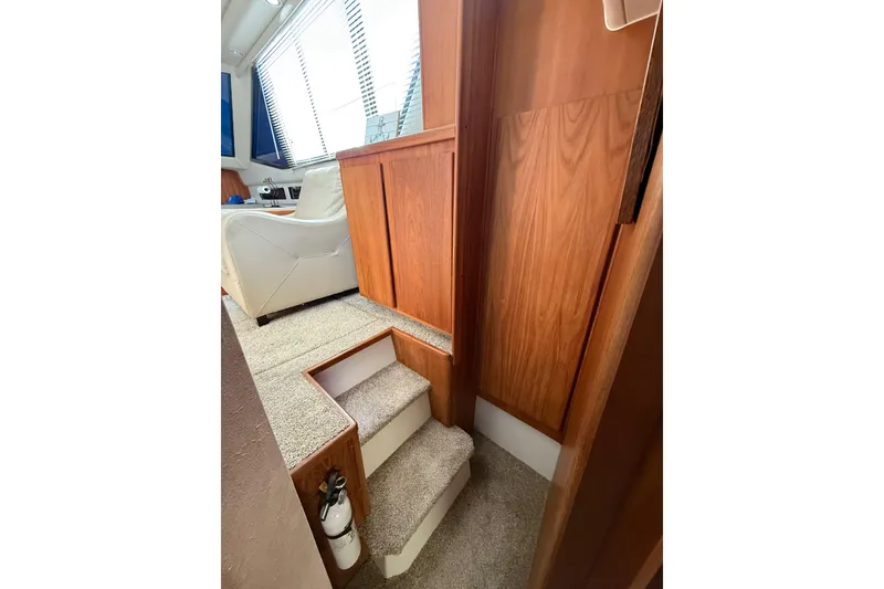 Slide: The Image of Interior of 1992 Carver 33 Aft Cabin Motor Yacht with carpeted stairs and wooden paneling. - 42