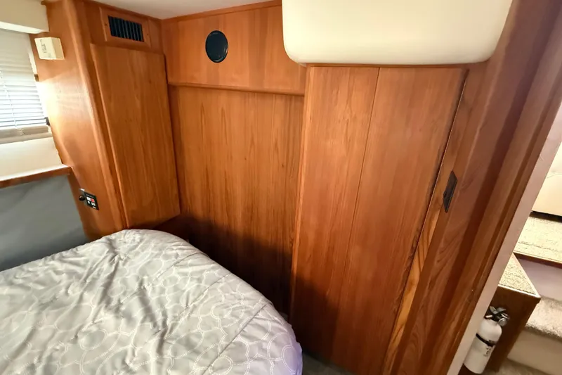 Slide: The Image of Interior of 1992 Carver 33 Aft Cabin Motor Yacht with wood paneling and bed. - 44