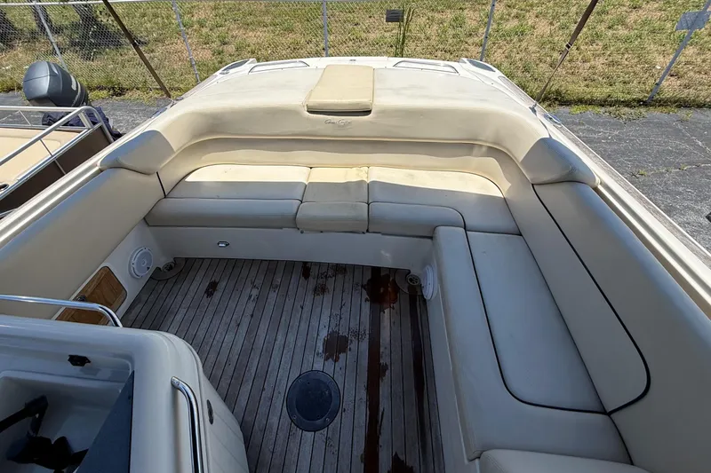 Slide: The Image of 2005 Chris-Craft Launch 28 boat interior with beige seating and wooden flooring. - 42
