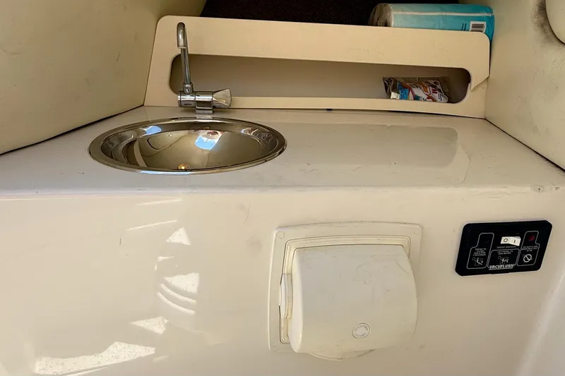 Slide: The Image of 2005 Chris-Craft Launch 28 boat interior with sink and storage compartment. - 26