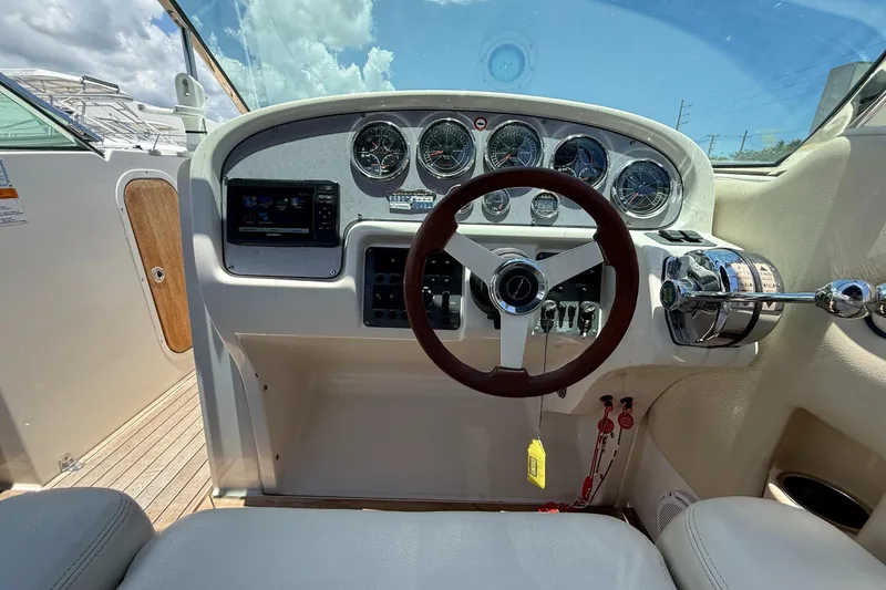 Slide: The Image of 2005 Chris-Craft Launch 28 dashboard with steering wheel and instrument panel. - 11