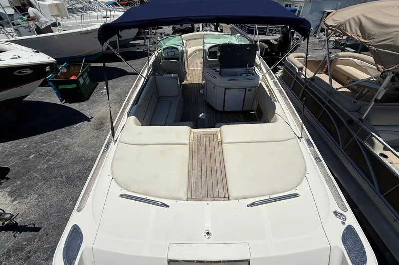 Slide: The Image of 2005 Chris-Craft Launch 28 boat with spacious seating and canopy, docked at marina. - 4