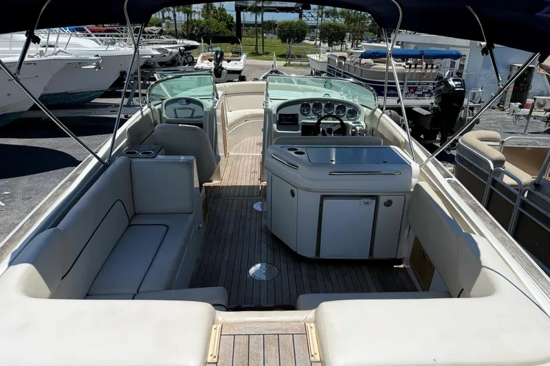 Slide: The Image of 2005 Chris-Craft Launch 28 boat interior with seating and dashboard, docked at marina. - 6