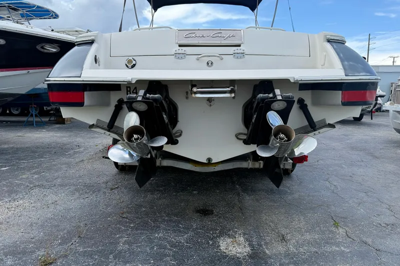 Slide: The Image of 2005 Chris-Craft Launch 28 boat rear view with dual propellers in a marina setting. - 53
