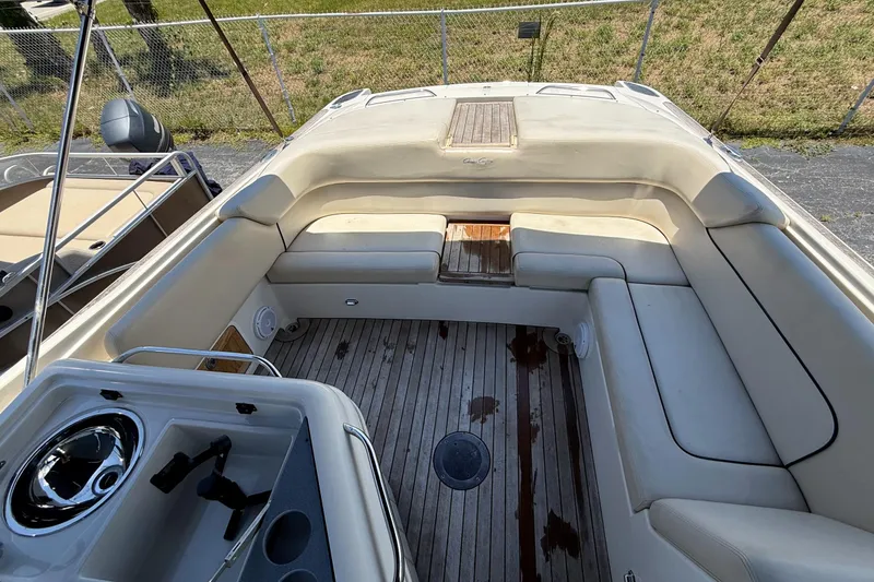 Slide: The Image of 2005 Chris-Craft Launch 28 boat interior with beige seating and wooden flooring. - 41
