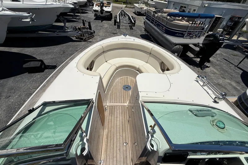 Slide: The Image of 2005 Chris-Craft Launch 28 boat with open deck and seating, parked in a marina. - 19