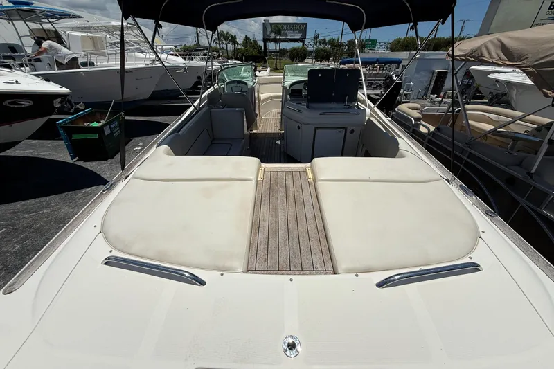 Slide: The Image of 2005 Chris-Craft Launch 28 boat with spacious seating and elegant design at a marina. - 5