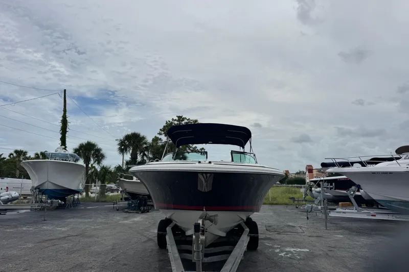 Slide: The Image of 2005 Chris-Craft Launch 28 boat on trailer, parked outdoors under cloudy sky. - 1