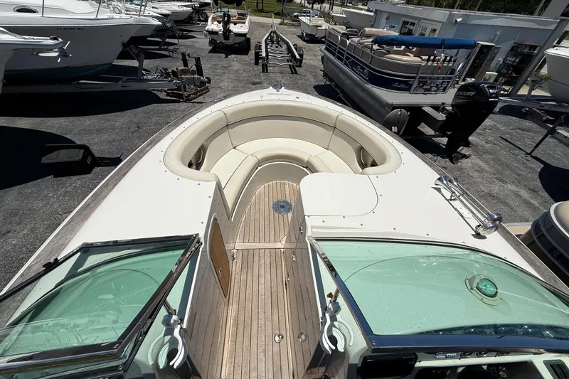 Slide: The Image of 2005 Chris-Craft Launch 28 boat with spacious seating, docked among other boats. - 20