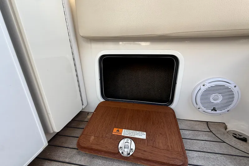 Slide: The Image of 2005 Chris-Craft Launch 28 boat interior with storage compartment and speaker. - 38