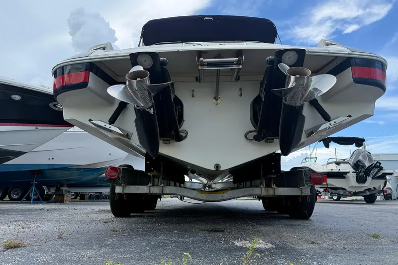Slide: The Image of Rear view of a 2005 Chris-Craft Launch 28 boat on a trailer, showcasing dual propellers. - 54