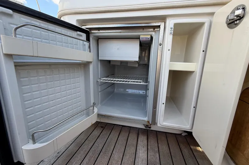 Slide: The Image of Open refrigerator on 2005 Chris-Craft Launch 28 boat, showcasing interior storage space. - 37