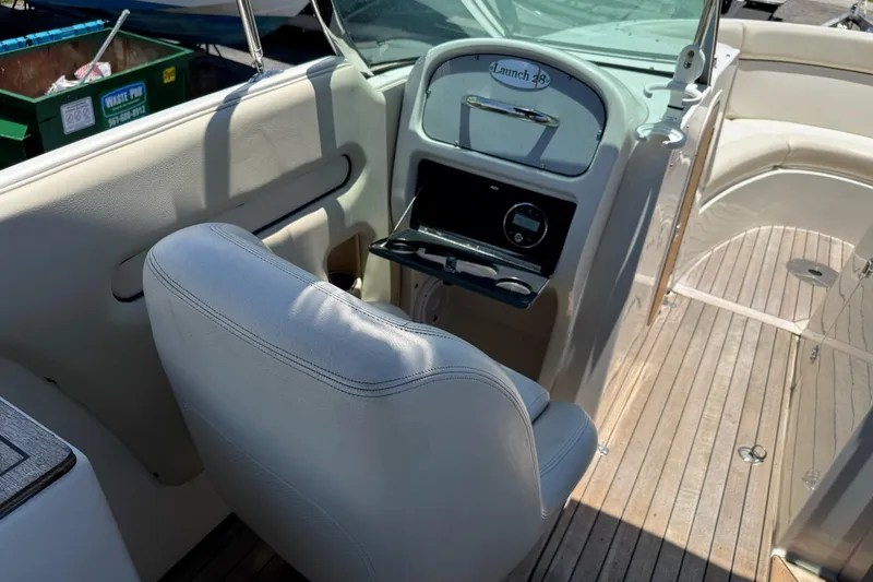 Slide: The Image of 2005 Chris-Craft Launch 28 boat interior with helm and seating area. - 17