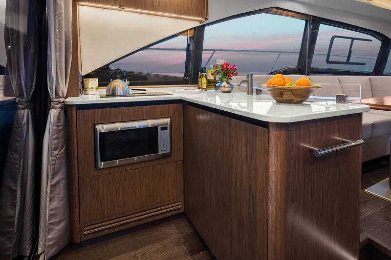 Slide: The Image of Manufacturer Provided Image: Modern kitchen area in 2018 Sea Ray Fly 460 yacht with microwave and fruit bowl. - 8