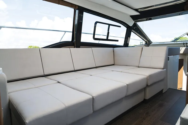 Slide: The Image of Manufacturer Provided Image: 2018 Sea Ray Fly 460 yacht interior with spacious beige seating. - 13