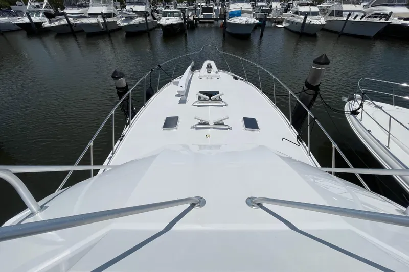 Slide: The Image of Bow view of 1990 Hatteras 45 Convertible yacht docked in a marina. - 40