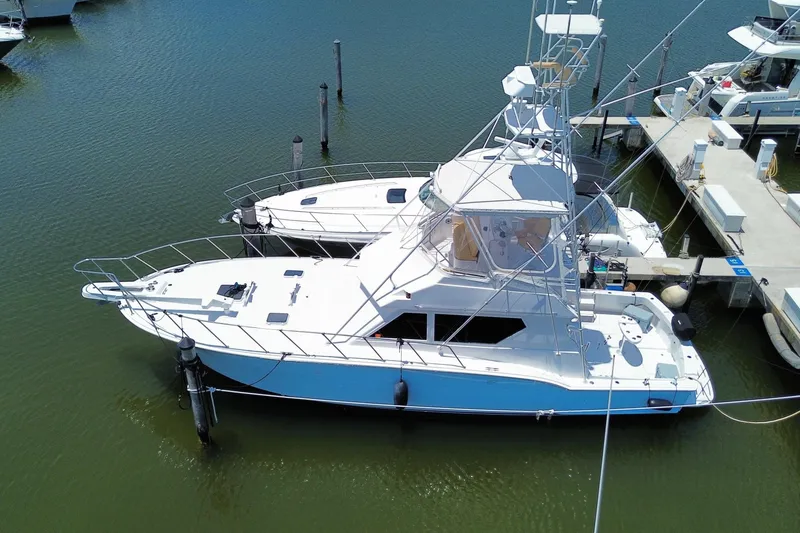 Slide: The Image of Aerial view of a 1990 Hatteras 45 Convertible yacht docked in a marina. - 10