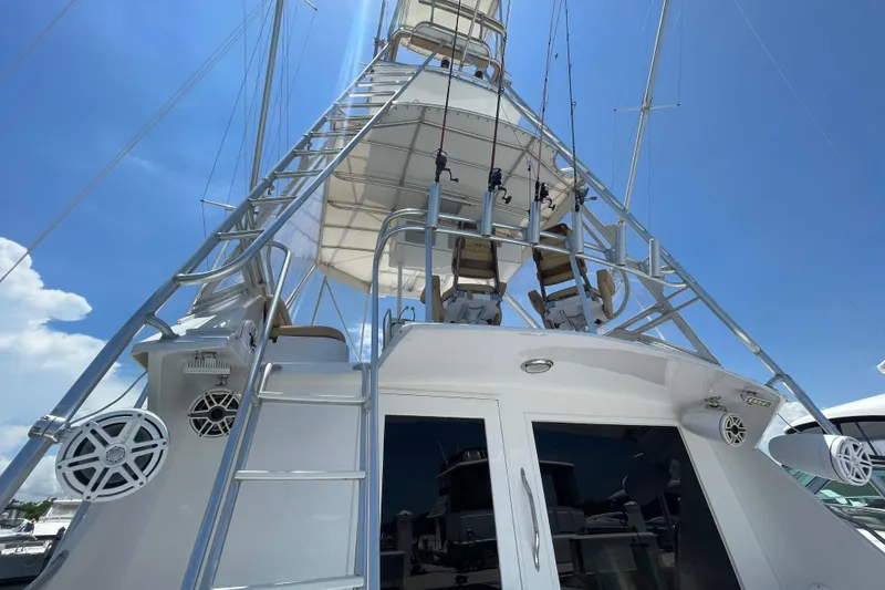 Slide: The Image of 1990 Hatteras 45 Convertible yacht with tower and fishing gear under clear blue sky. - 31