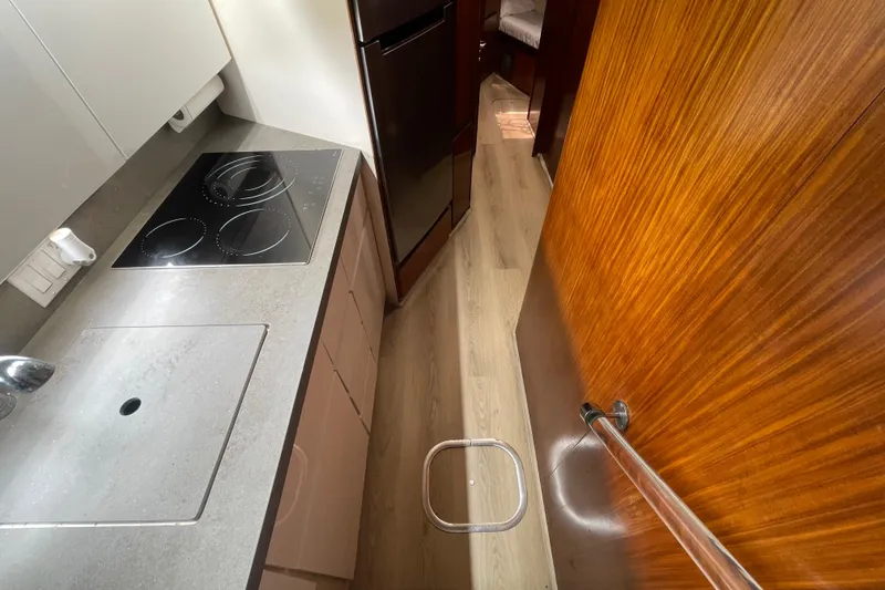 Slide: The Image of Compact kitchen area in a 1990 Hatteras 45 Convertible yacht, featuring modern appliances. - 57