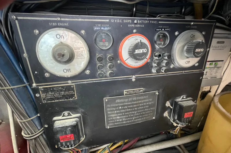 Slide: The Image of Control panel of a 1990 Hatteras 45 Convertible boat, featuring engine and battery switches. - 83