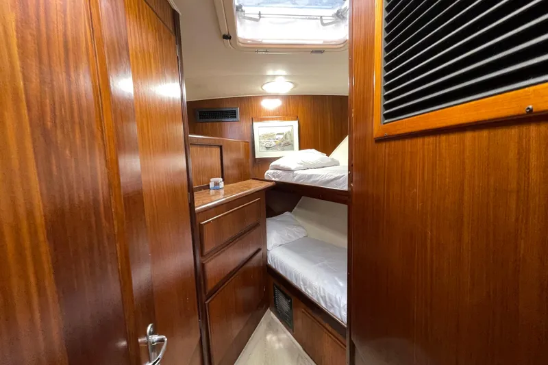 Slide: The Image of Cabin interior of 1990 Hatteras 45 Convertible yacht with wooden finish and bunk beds. - 71