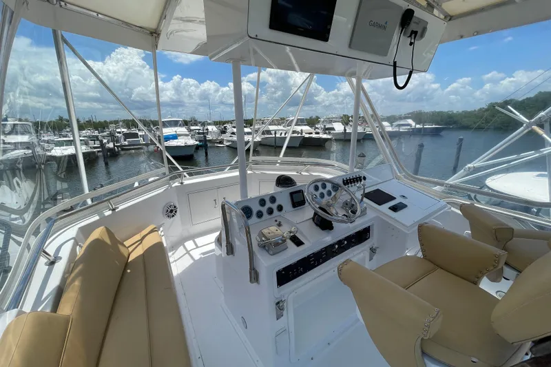 Slide: The Image of Helm of 1990 Hatteras 45 Convertible yacht with marina view. - 33