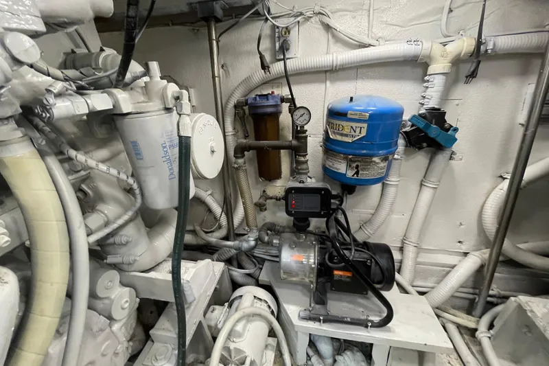 Slide: The Image of Engine room of 1990 Hatteras 45 Convertible with mechanical components and piping. - 81