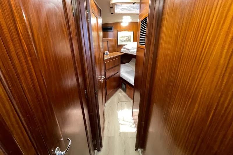 Slide: The Image of Interior of 1990 Hatteras 45 Convertible yacht with wooden paneling and bunk beds. - 68