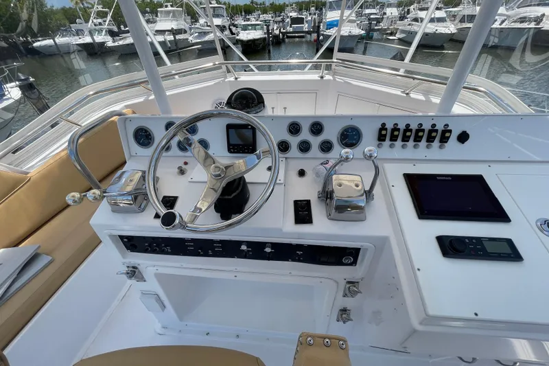Slide: The Image of Cockpit of 1990 Hatteras 45 Convertible yacht with steering wheel and navigation instruments. - 36