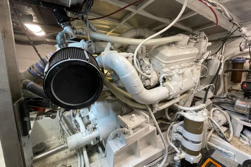 Slide: The Image of Engine room of a 1990 Hatteras 45 Convertible yacht, showcasing complex machinery. - 79