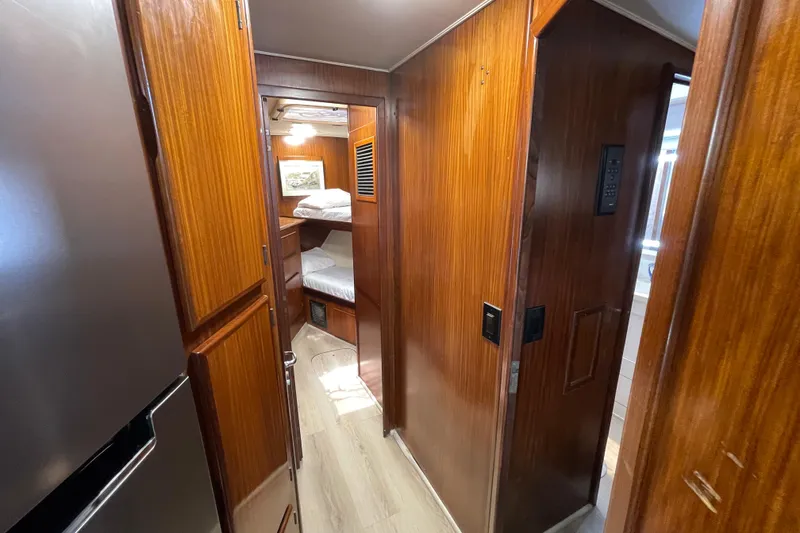 Slide: The Image of Interior of 1990 Hatteras 45 Convertible yacht with wooden paneling and bunk beds. - 59