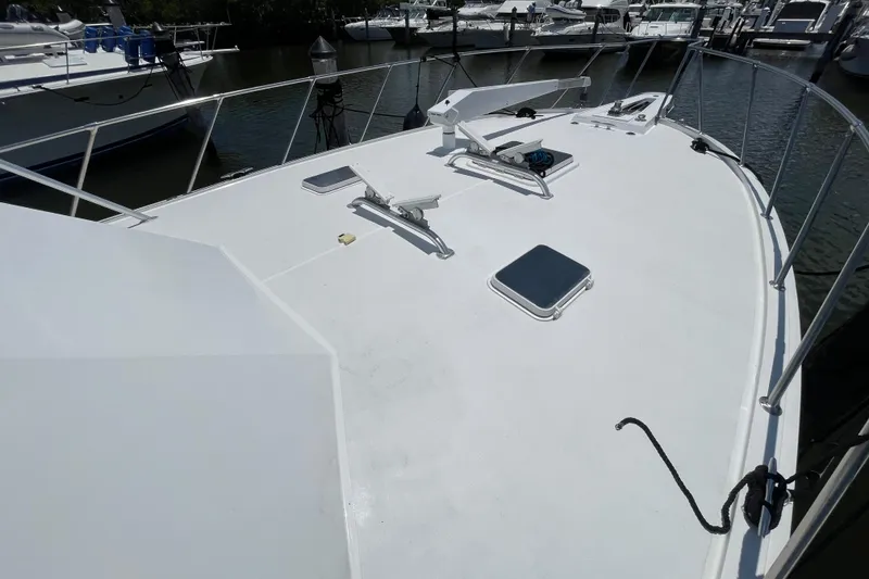 Slide: The Image of 1990 Hatteras 45 Convertible yacht deck with railing, docked in marina. - 43
