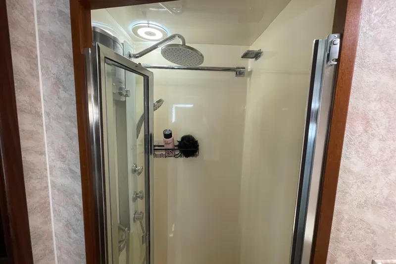 Slide: The Image of Shower area inside a 1990 Hatteras 45 Convertible yacht, featuring modern fixtures. - 62