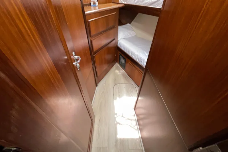 Slide: The Image of Interior cabin of 1990 Hatteras 45 Convertible yacht with wooden finish and bunk beds. - 70