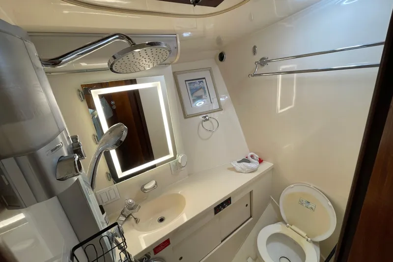 Slide: The Image of Bathroom interior of 1990 Hatteras 45 Convertible yacht, featuring shower and toilet. - 69