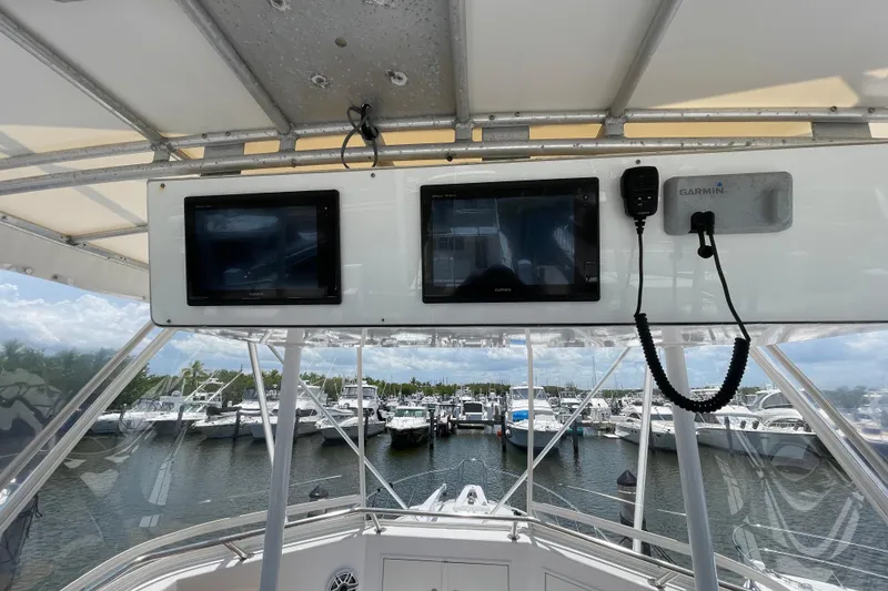 Slide: The Image of Helm of 1990 Hatteras 45 Convertible yacht with Garmin navigation displays at marina. - 37